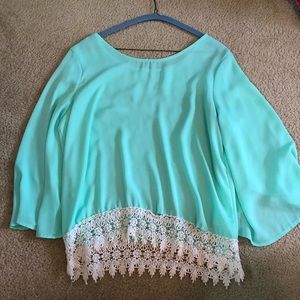 turquoise top with lace detailing at the bottom